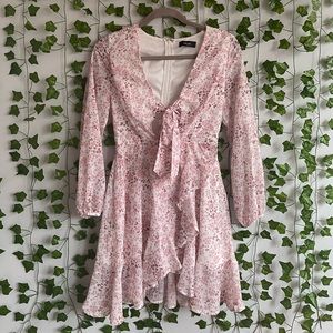 Size XS flowy floral long sleeved Trac mini dress with a tie waist.